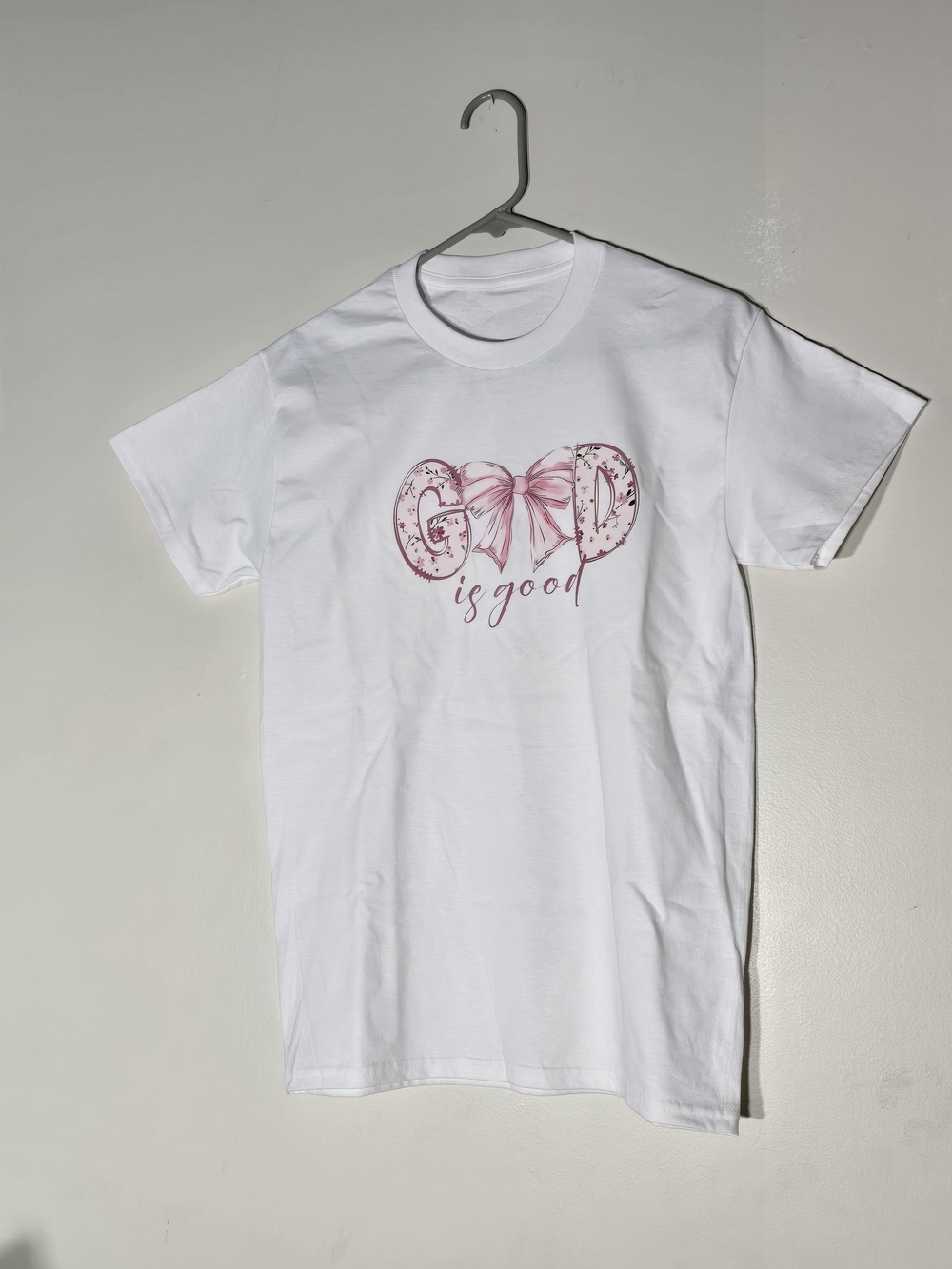 White 'God is Good' Short Sleeve Tee with Pink Script. Size S.